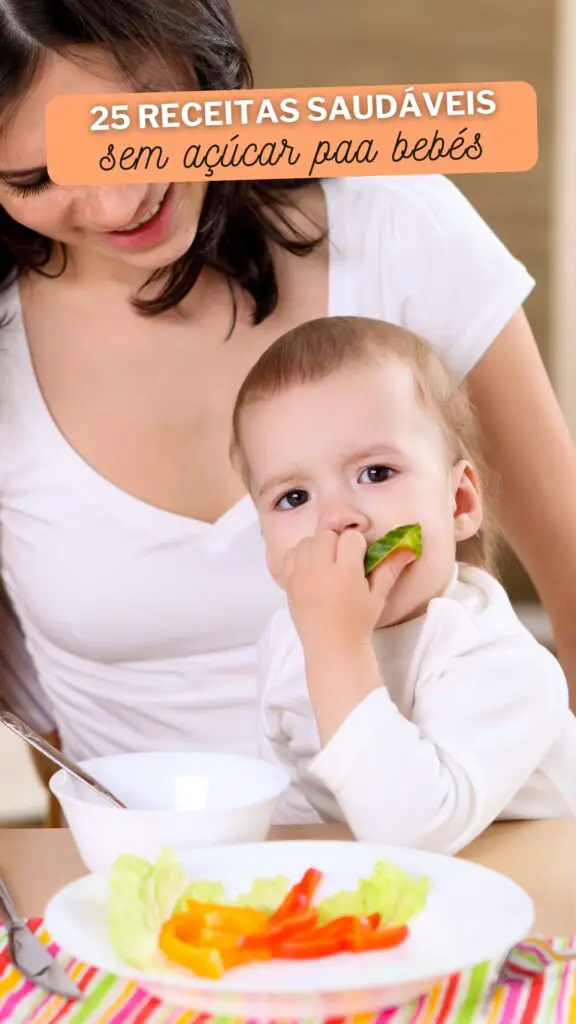 Mãe sorridente a partilhar uma refeição saudável com o bebé, com um prato colorido de vegetais frescos na mesa.